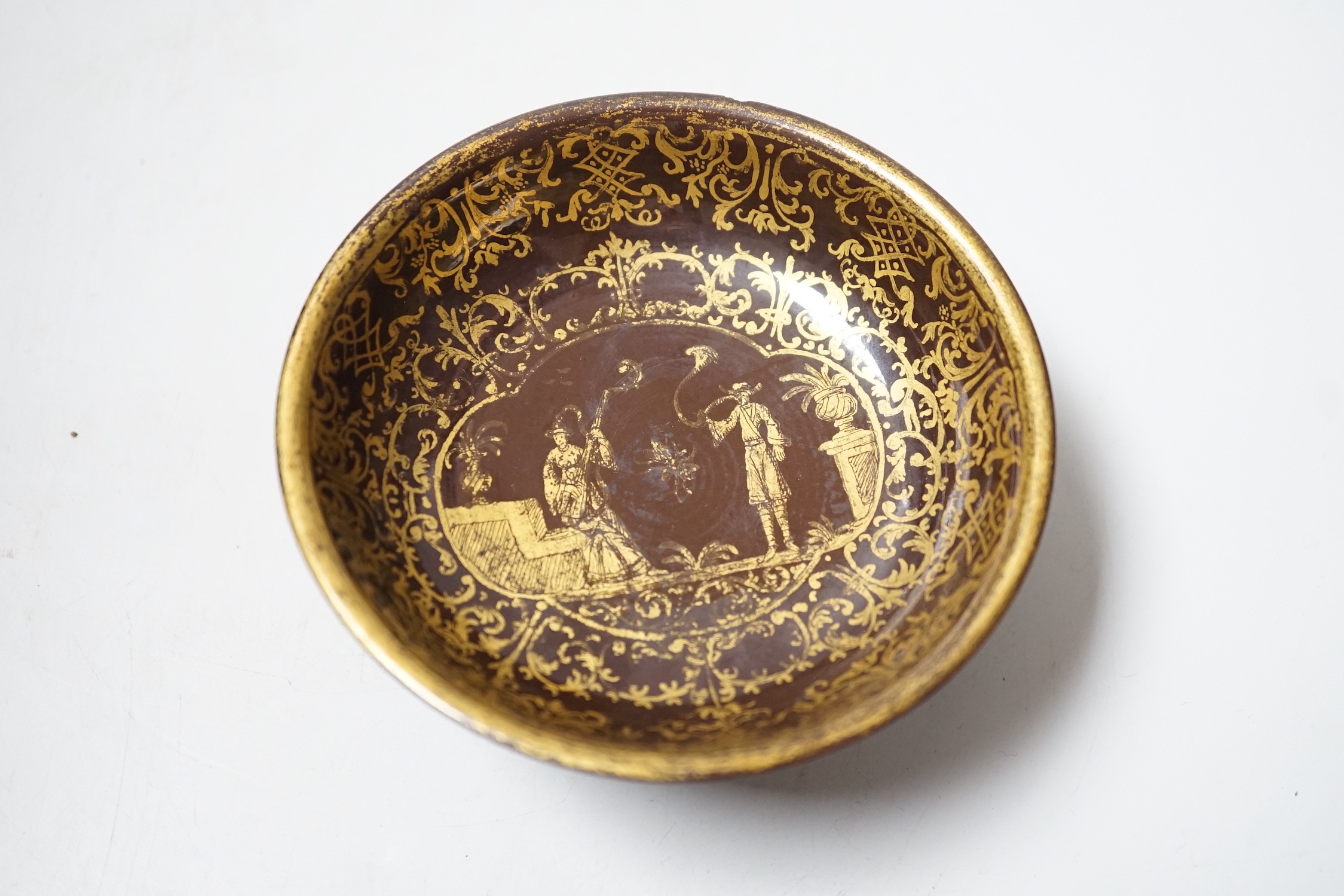 A Bayreuth glazed and gilded footed dish, c.1730-40, in imitation of Böttger stoneware, 11.2cm diameter, foot glued